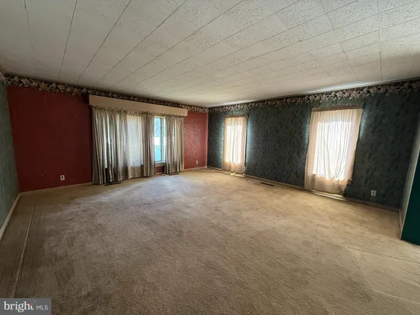 a view of an empty room with windows