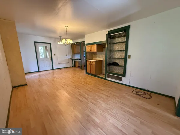 an empty room with a fireplace and cabinet