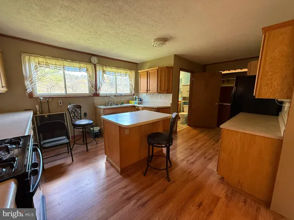 a kitchen with stainless steel appliances a refrigerator and a sink