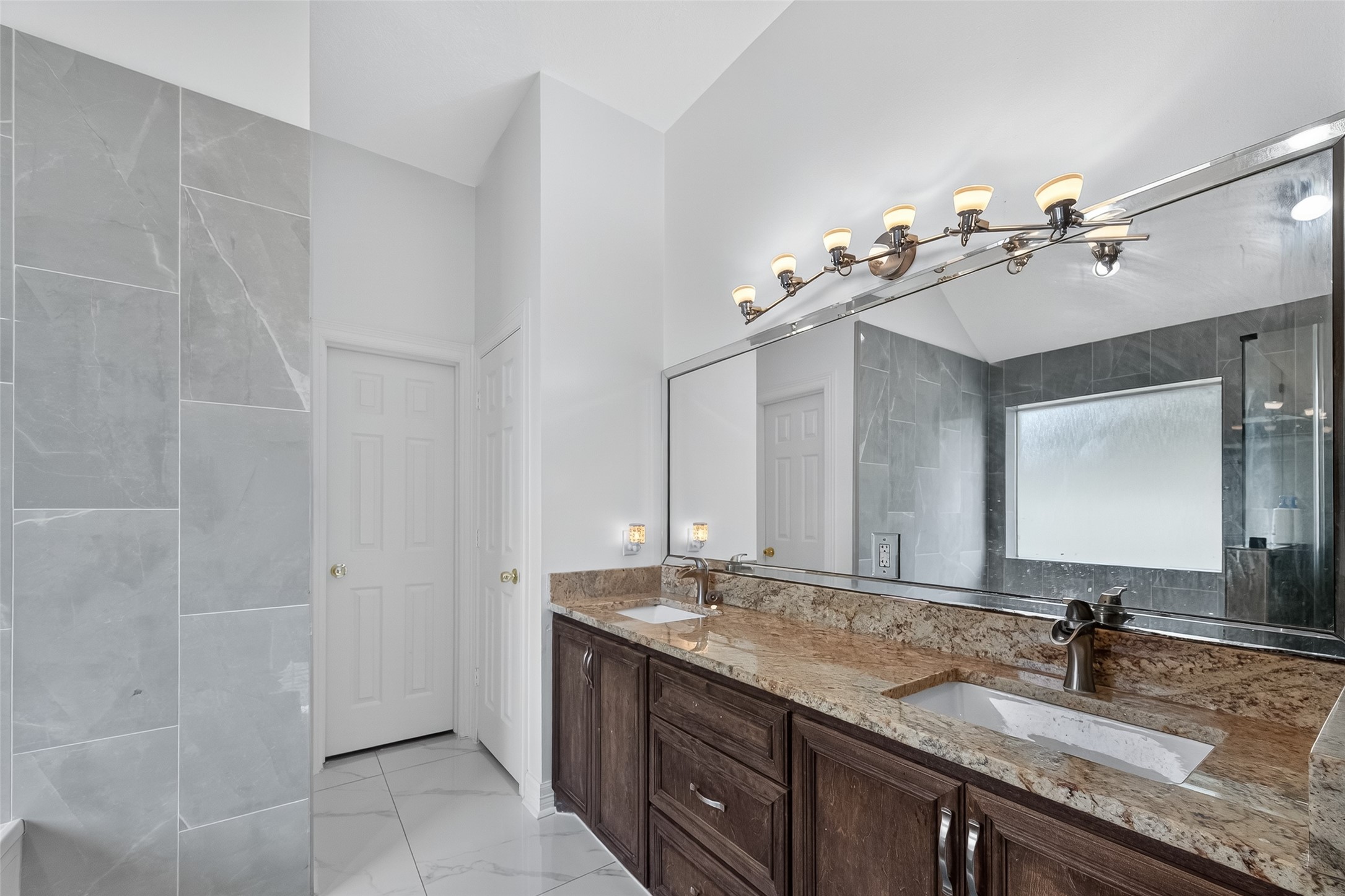 4917 Sycamore Avenue Pasadena, TX 77503 - Photo 36 of 46 a bathroom with a granite countertop sink a mirror and a shower