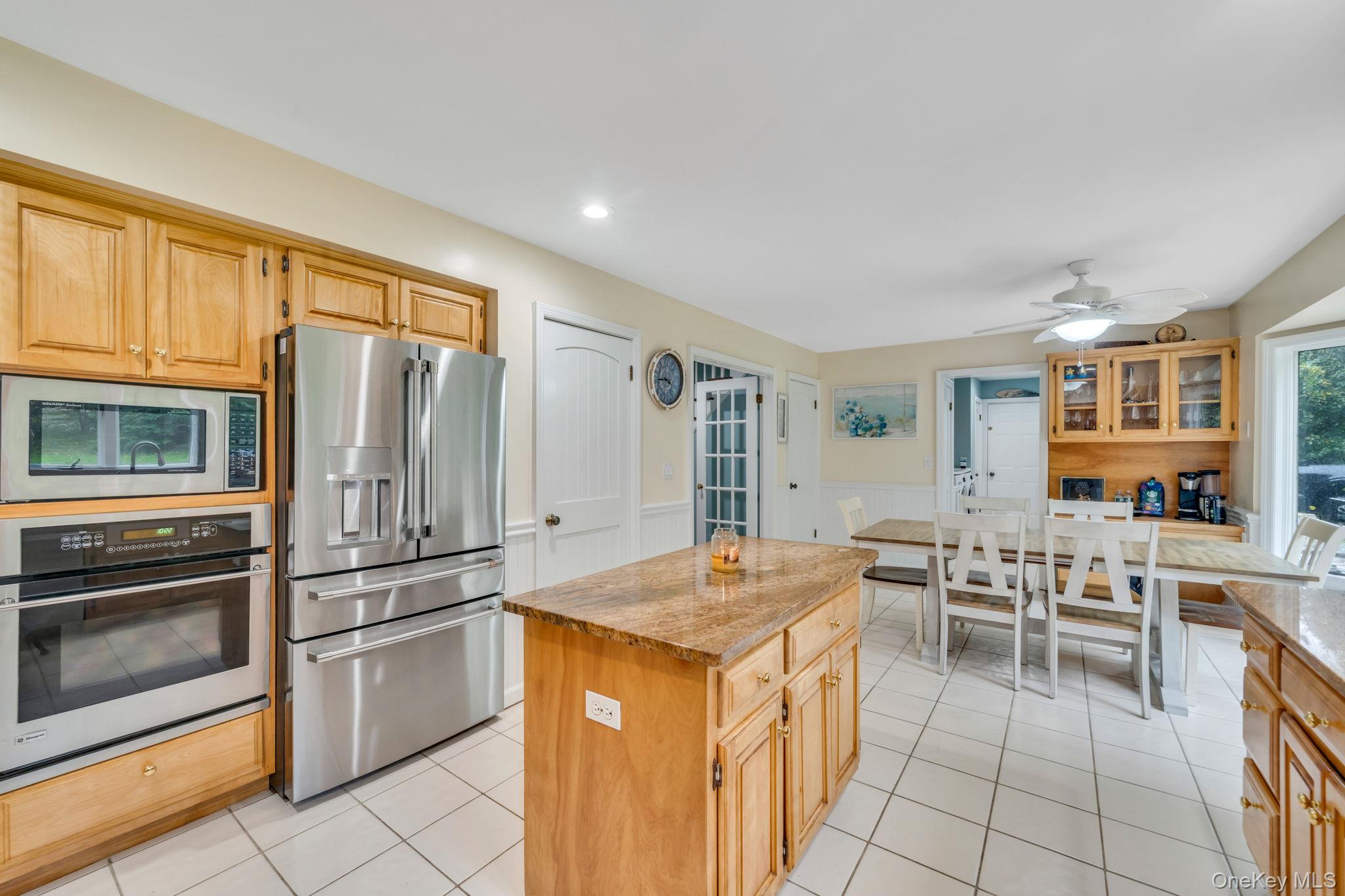 27 Tower Hill Road Shoreham, NY 11786 - Photo 12 of 49 a kitchen that has a lot of white cabinets and stainless steel appliances
