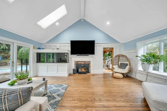 a living room with fireplace furniture and a flat screen tv