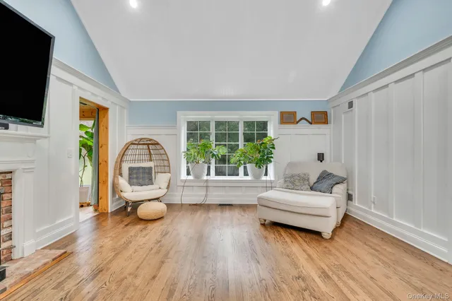 a living room with fireplace furniture and a flat screen tv