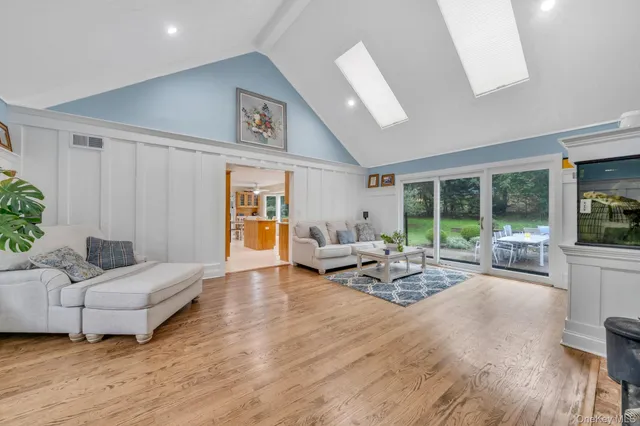 a living room with furniture and large windows