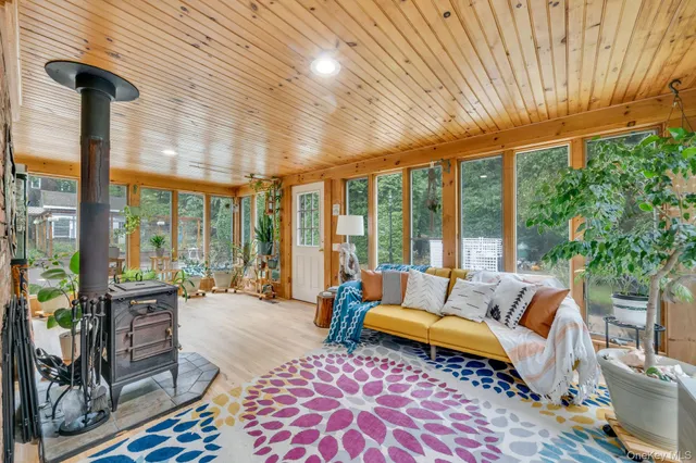 a living room with furniture and a floor to ceiling window