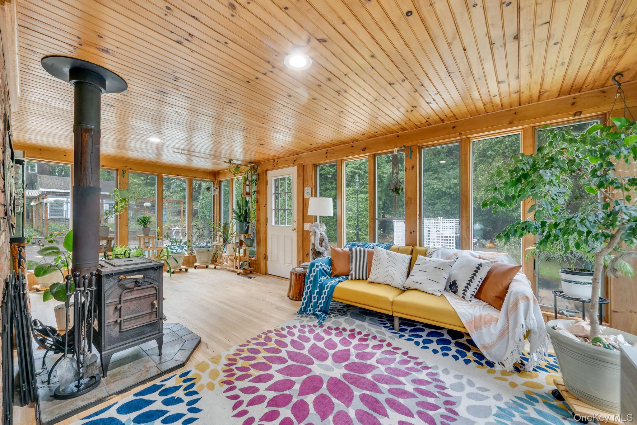27 Tower Hill Road Shoreham, NY 11786 - Photo 18 of 49 a living room with furniture and a floor to ceiling window