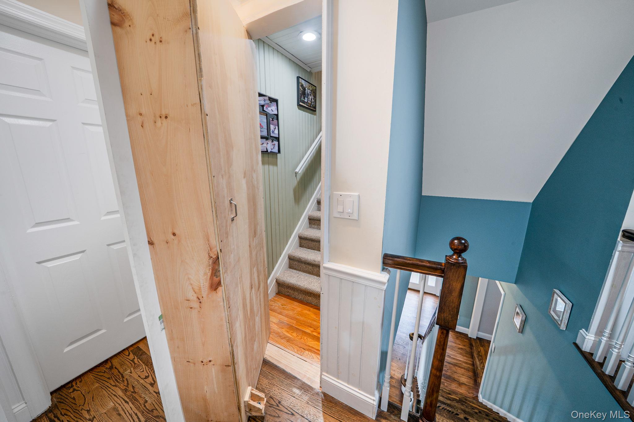 27 Tower Hill Road Shoreham, NY 11786 - Photo 21 of 49 a view of a livingroom with wooden floor and stairs
