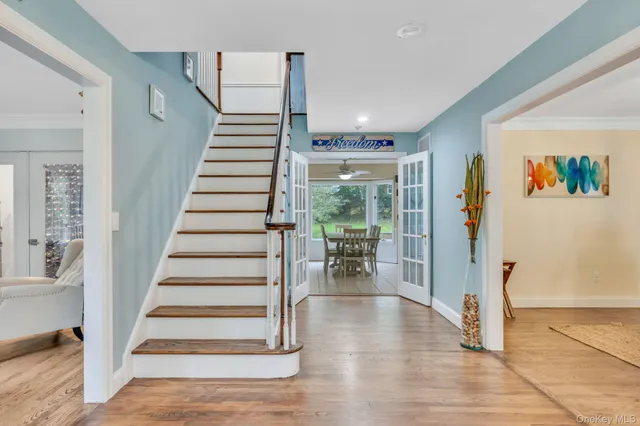 a view of entryway with wooden floor and windows