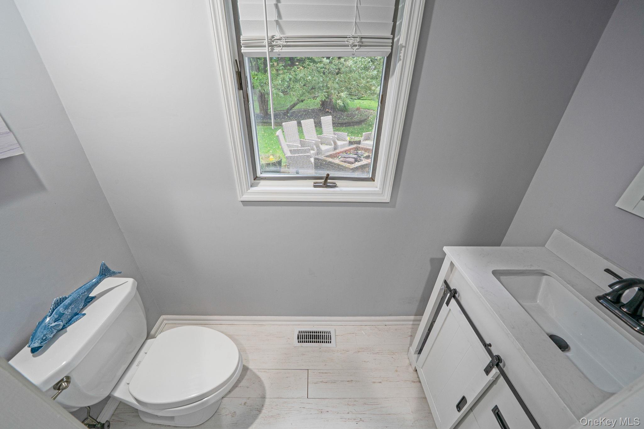 27 Tower Hill Road Shoreham, NY 11786 - Photo 32 of 49 a white toilet sitting next to a bathroom sink