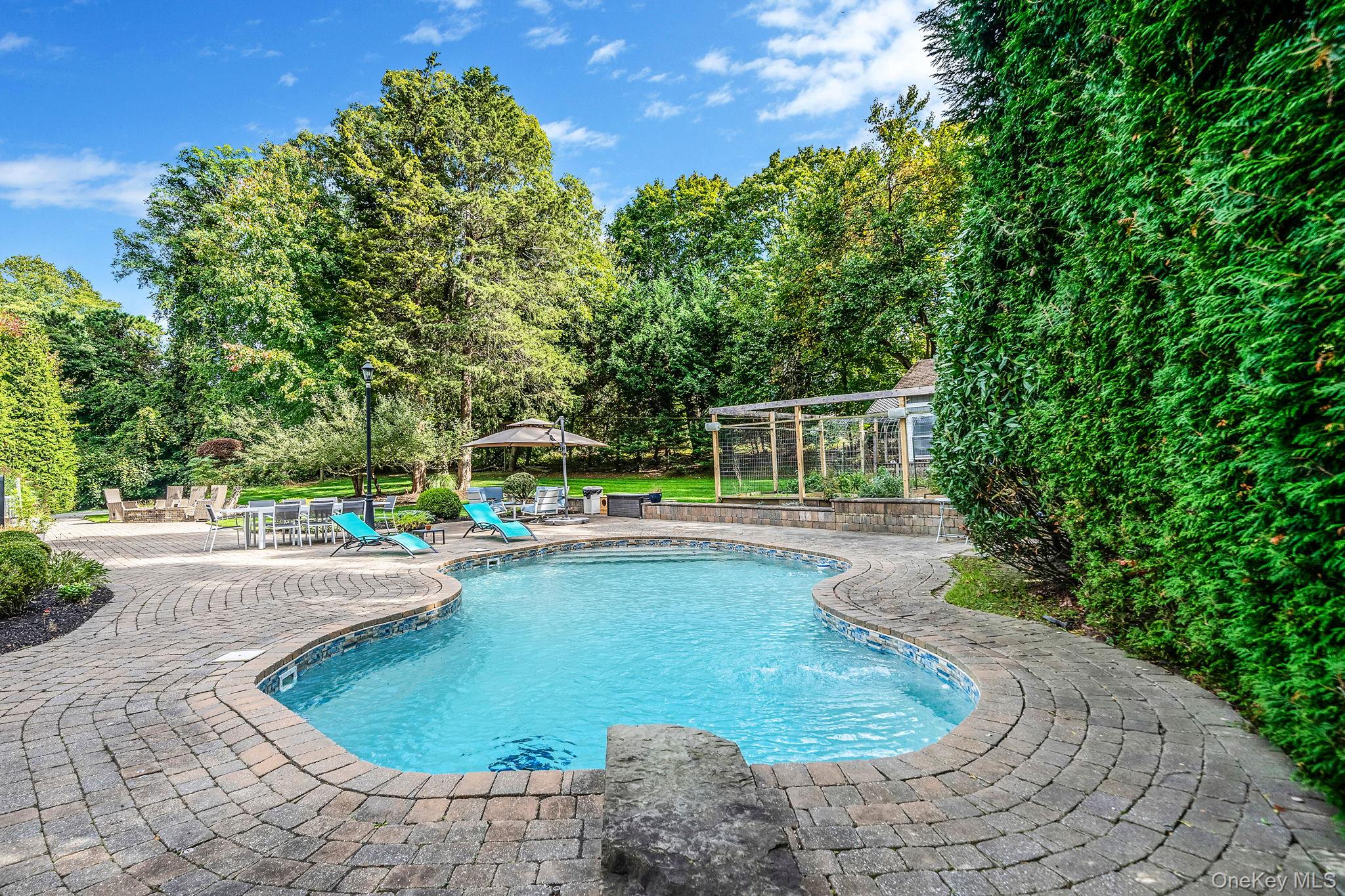 27 Tower Hill Road Shoreham, NY 11786 - Photo 39 of 49 a view of a swimming pool with a patio