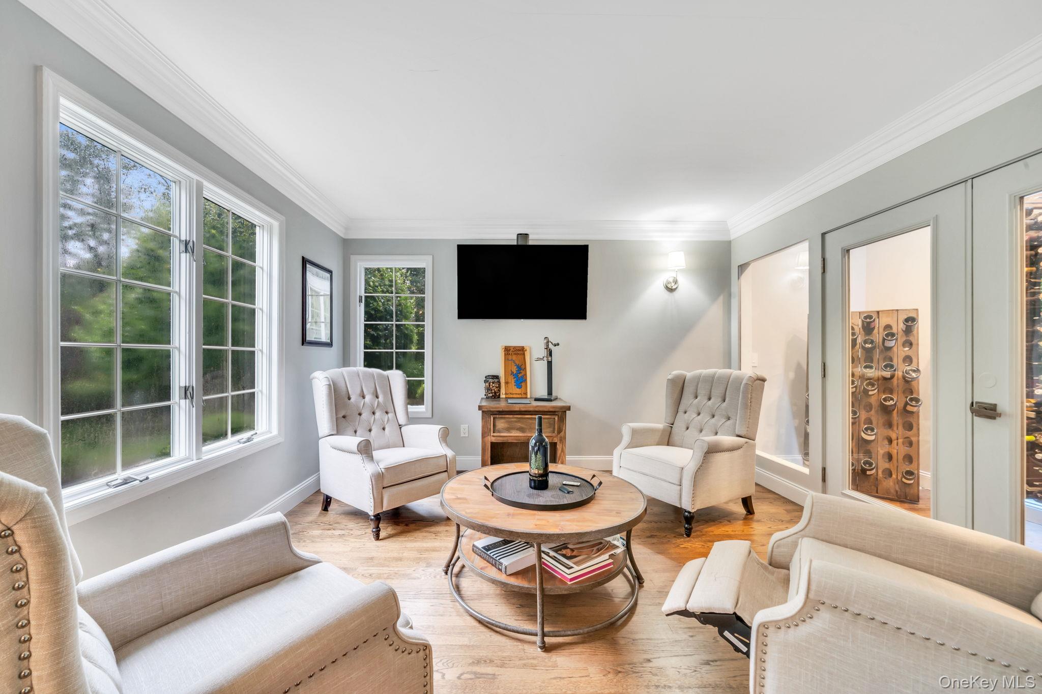 27 Tower Hill Road Shoreham, NY 11786 - Photo 4 of 49 a living room with furniture a flat screen tv and a large window