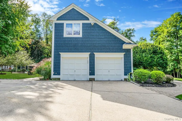 a view of a house with a yard and garage