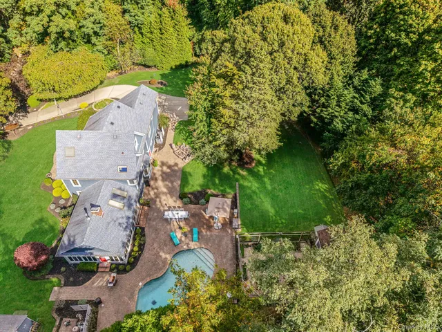 an aerial view of a house with a yard