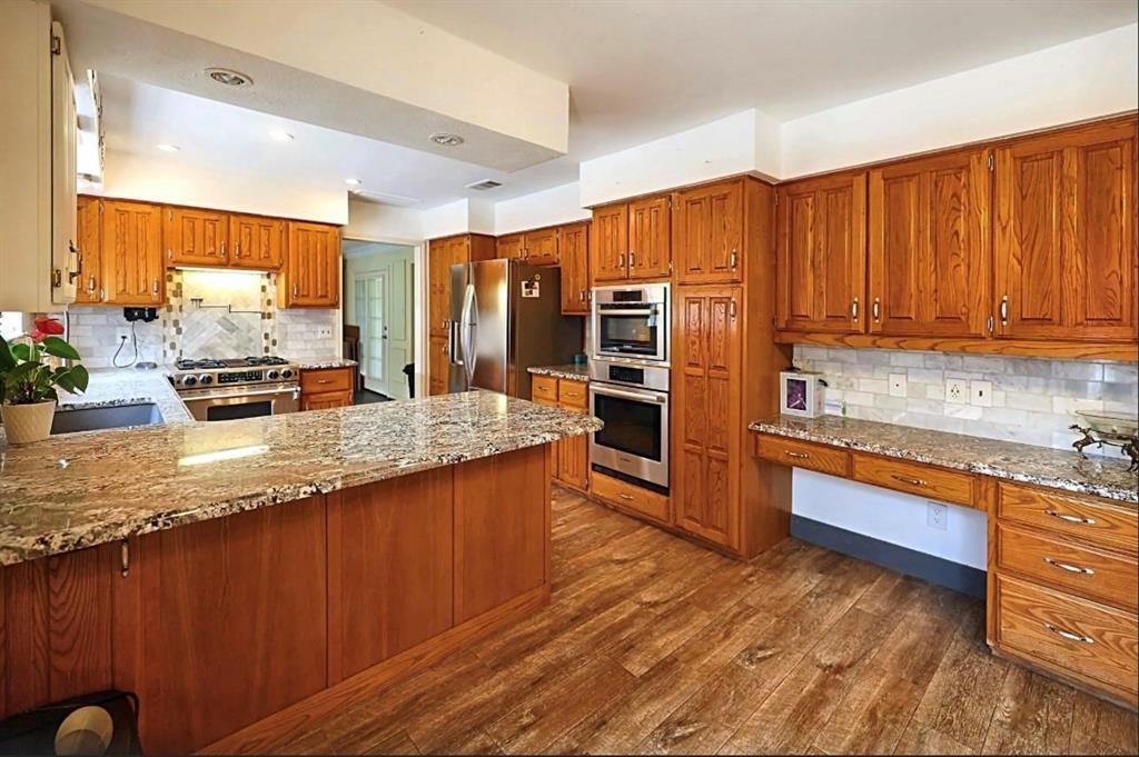 3439 South 271 Bonham, TX 75418 - Photo 2 of 36 a kitchen with stainless steel appliances granite countertop a stove a sink and a refrigerator