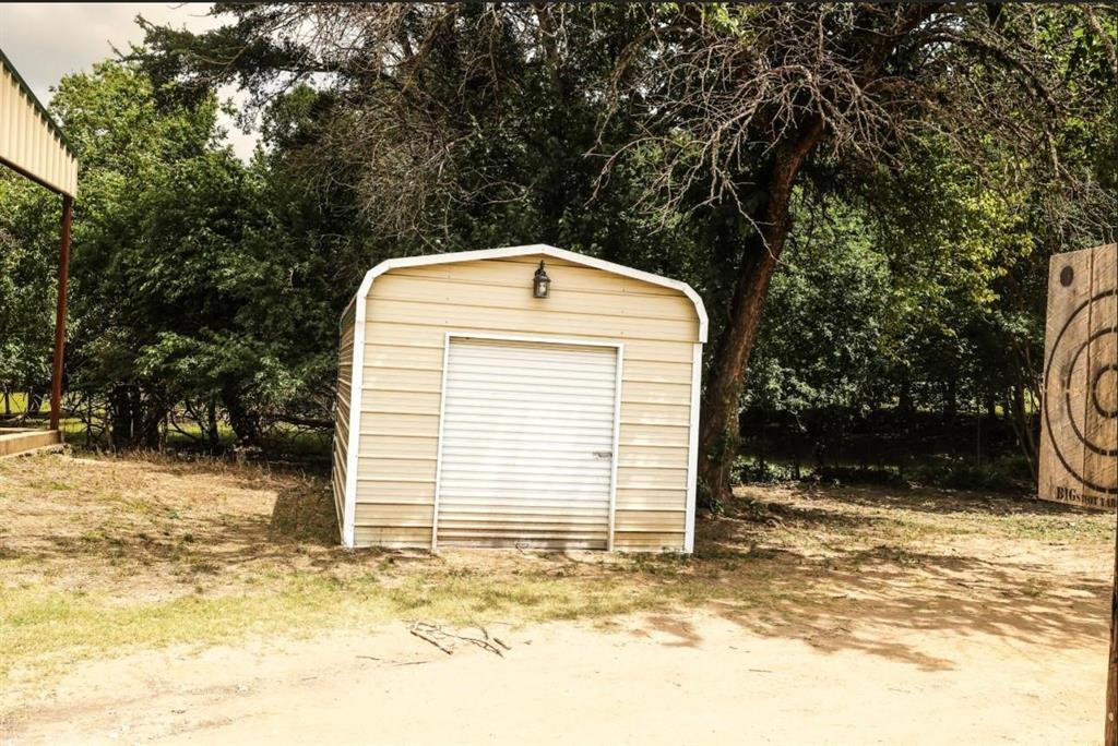 3439 South 271 Bonham, TX 75418 - Photo 24 of 36 a front view of a house with a yard