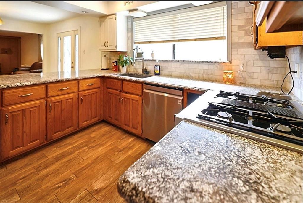 3439 South 271 Bonham, TX 75418 - Photo 3 of 36 a kitchen with wooden cabinets and a sink