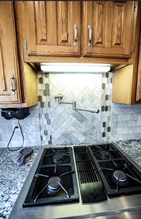 3439 South 271 Bonham, TX 75418 - Photo 4 of 36 a kitchen with granite countertop a stove and cabinets
