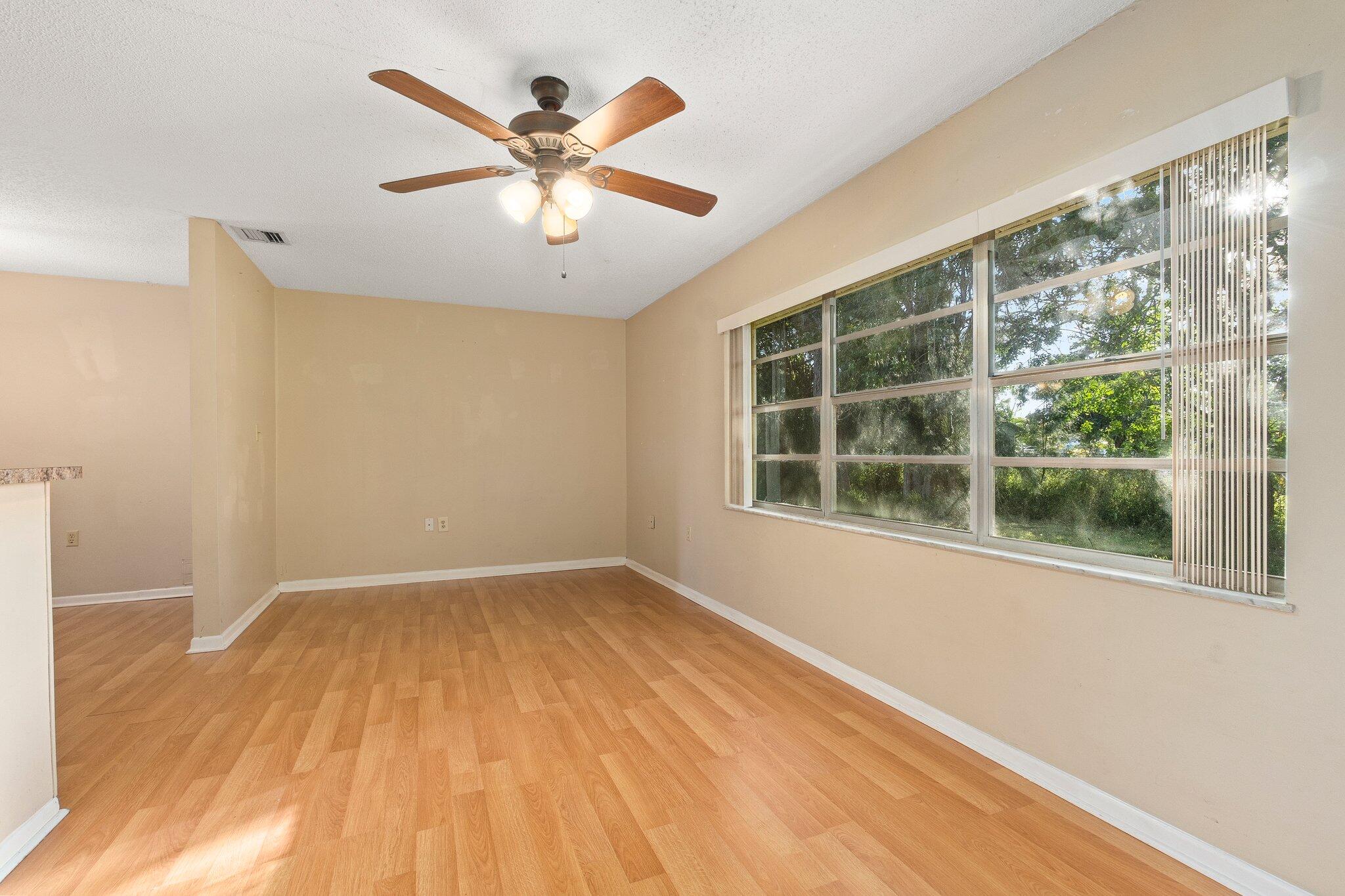 5901 Sunset Boulevard Fort Pierce, FL 34982 - Photo 12 of 26 an empty room with wooden floor and windows