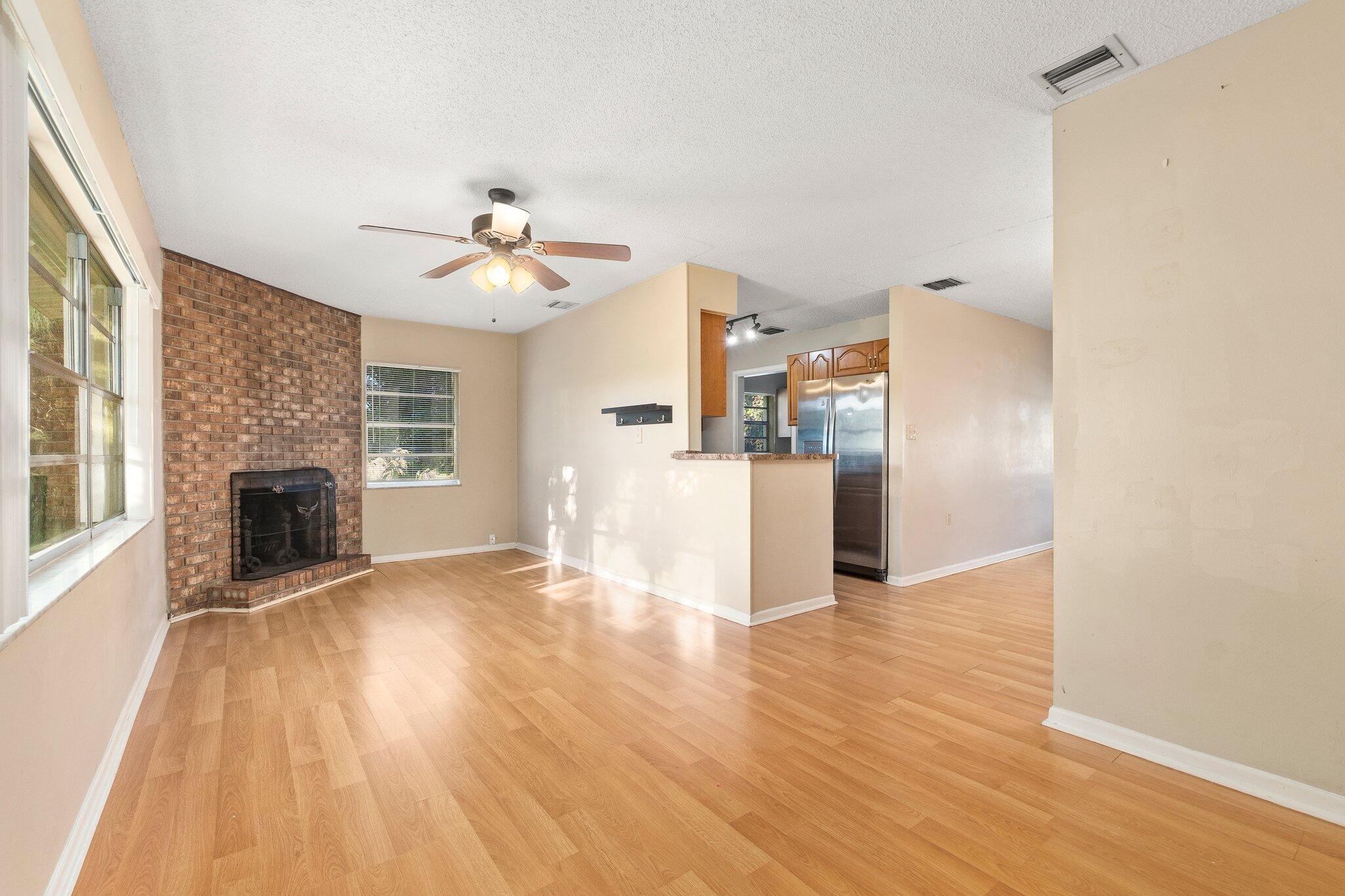 5901 Sunset Boulevard Fort Pierce, FL 34982 - Photo 13 of 26 a view of a kitchen with a stove cabinets wooden floor and a kitchen view