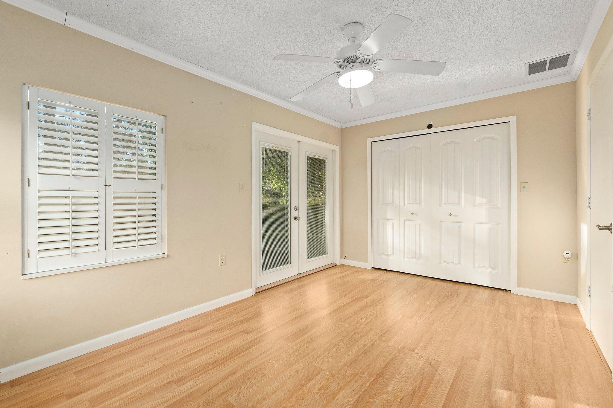 5901 Sunset Boulevard Fort Pierce, FL 34982 - Photo 17 of 26 a view of an empty room with wooden floor and a window