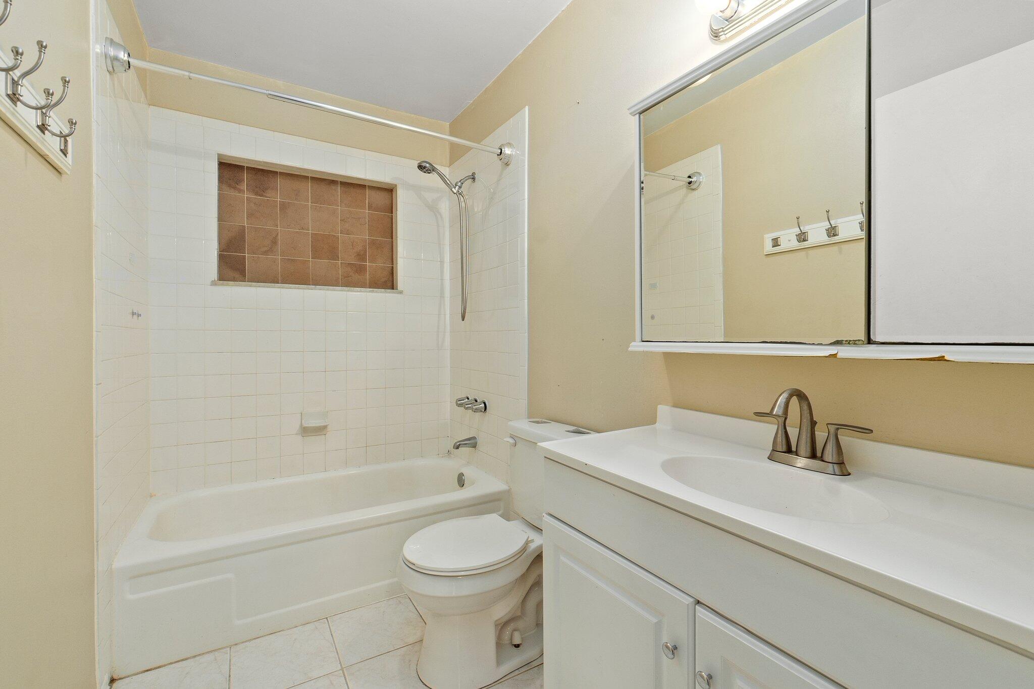 5901 Sunset Boulevard Fort Pierce, FL 34982 - Photo 19 of 26 a bathroom with a sink a toilet and shower