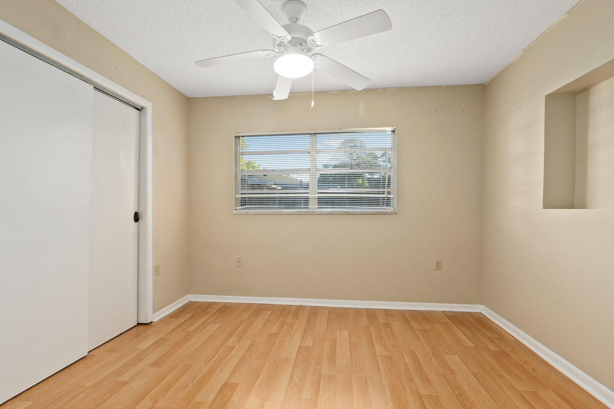 5901 Sunset Boulevard Fort Pierce, FL 34982 - Photo 20 of 26 wooden floor in an empty room with a window