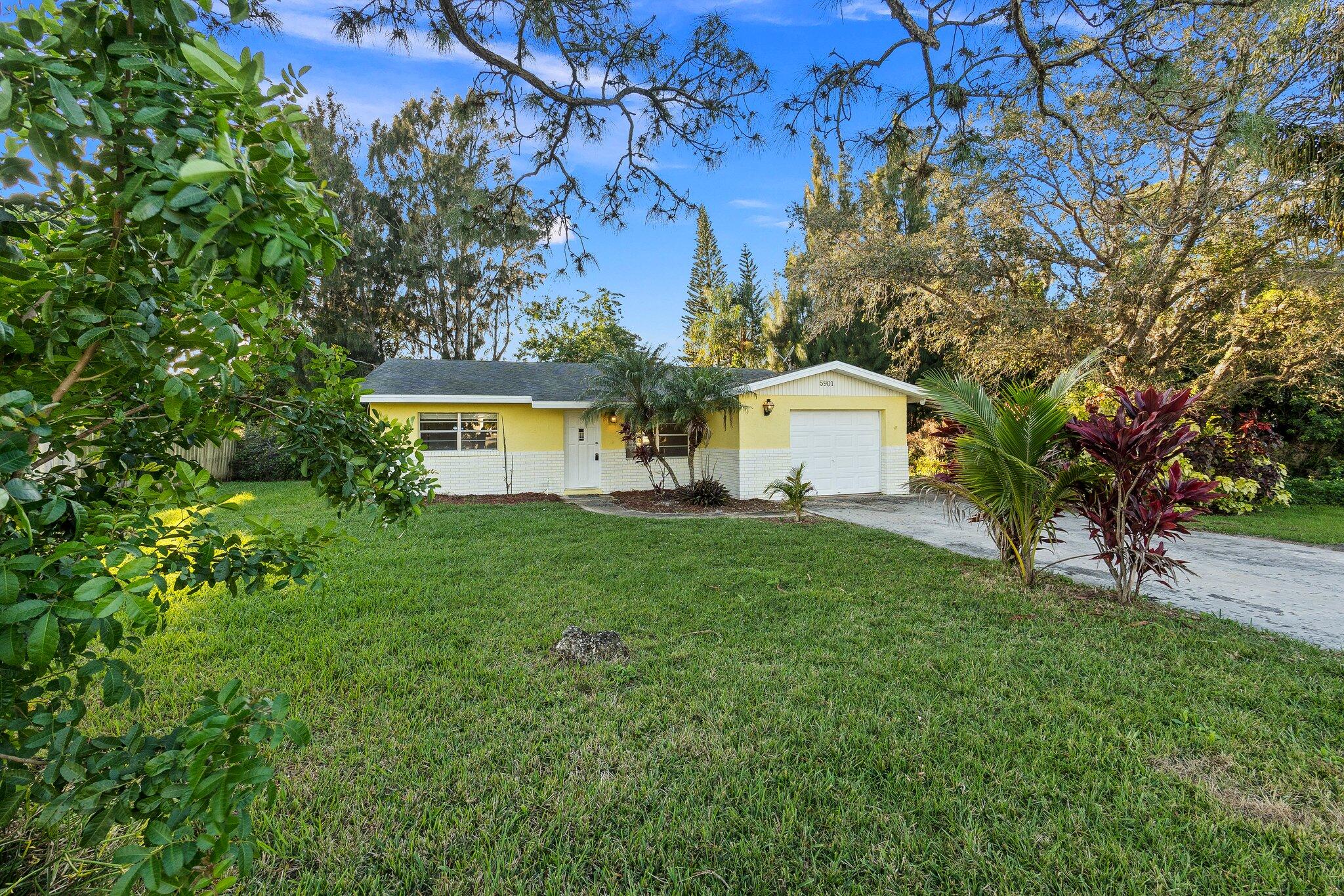 5901 Sunset Boulevard Fort Pierce, FL 34982 - Photo 2 of 26 a view of house with backyard and a garden