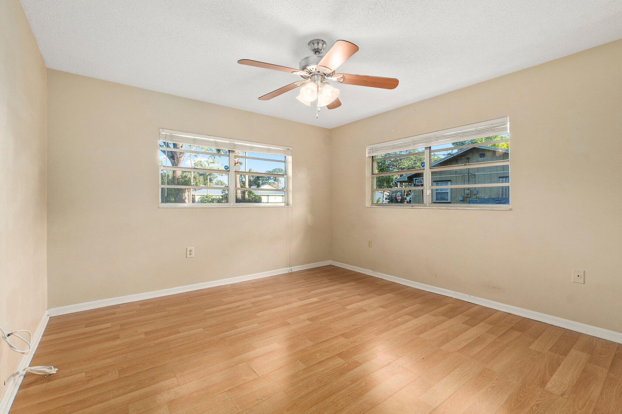 5901 Sunset Boulevard Fort Pierce, FL 34982 - Photo 21 of 26 a view of an empty room with wooden floor and a window