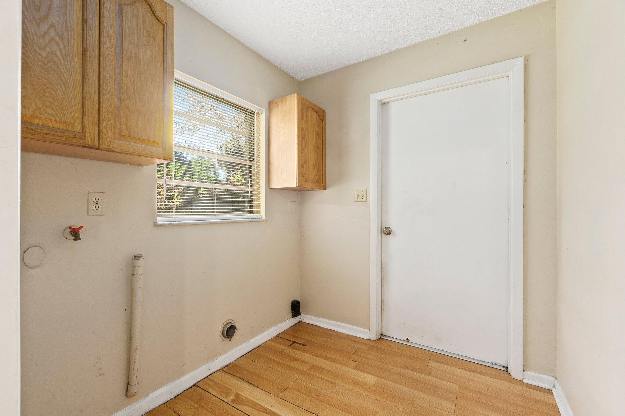 5901 Sunset Boulevard Fort Pierce, FL 34982 - Photo 23 of 26 a view of an empty room with wooden floor and a window