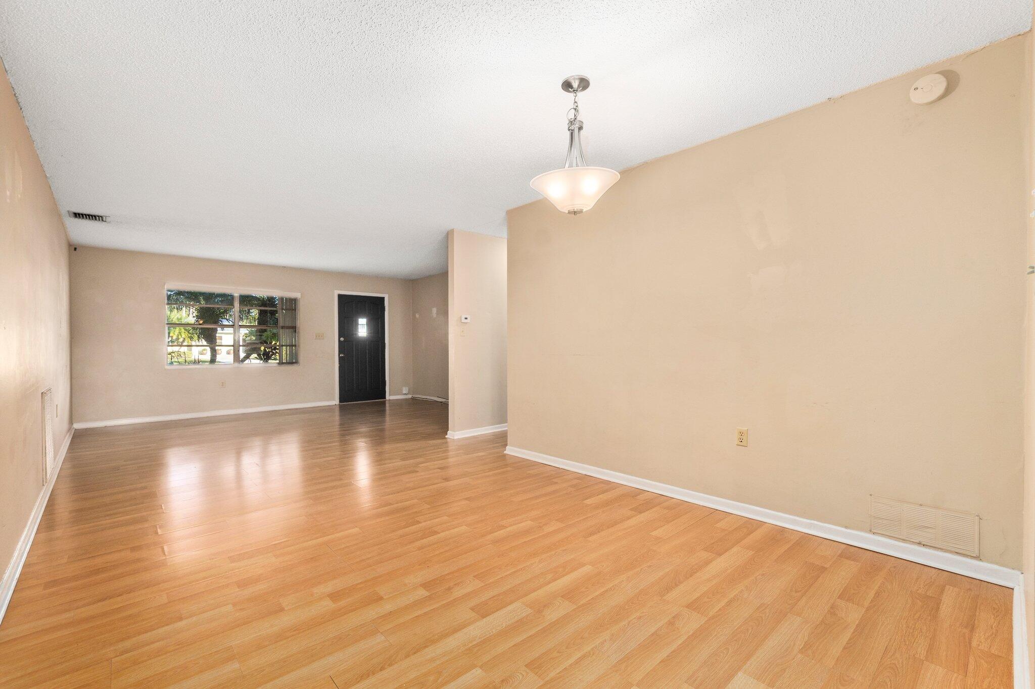 5901 Sunset Boulevard Fort Pierce, FL 34982 - Photo 5 of 26 a view of an empty room with window and wooden floor