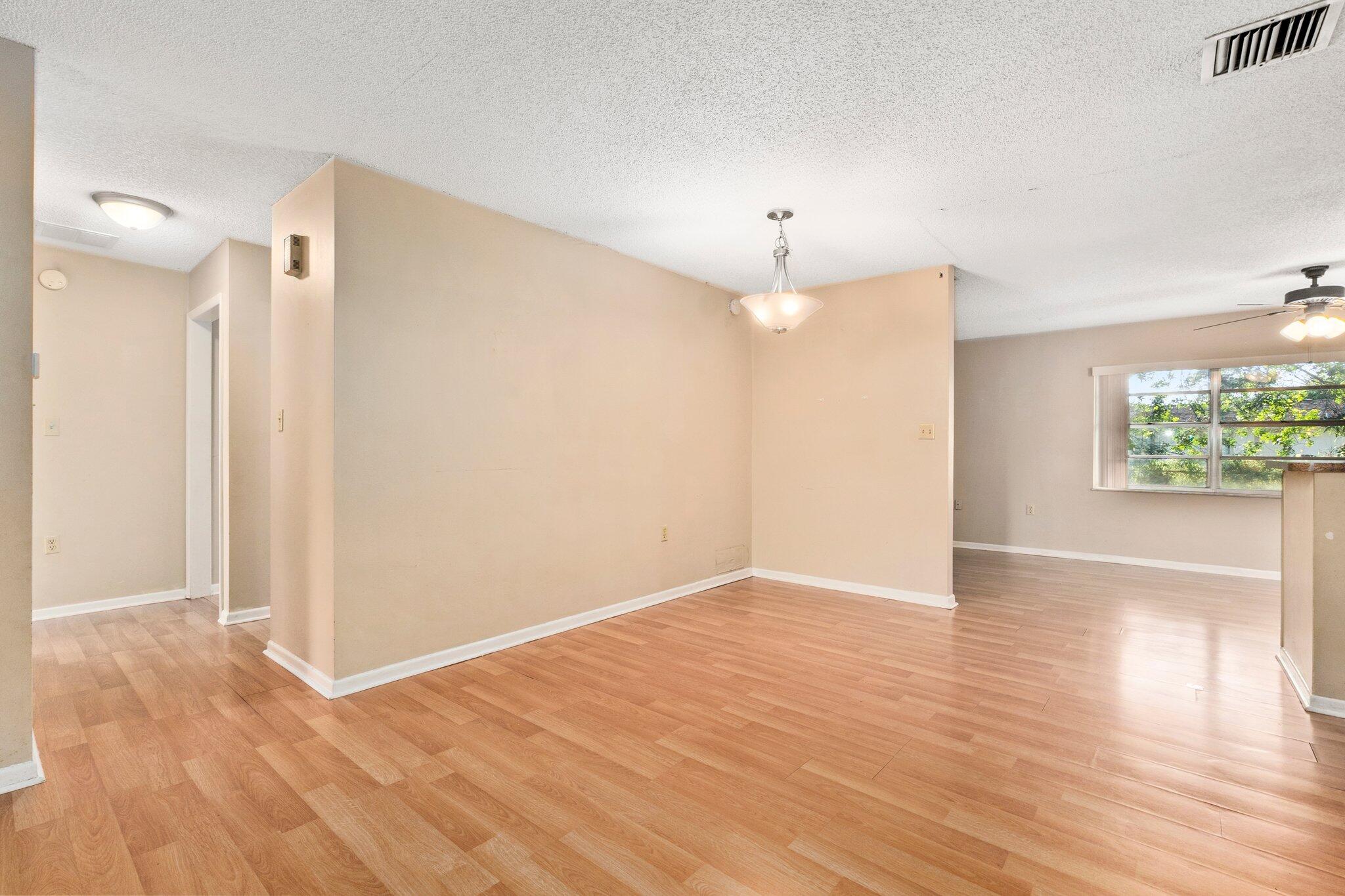 5901 Sunset Boulevard Fort Pierce, FL 34982 - Photo 7 of 26 a view of an empty room with wooden floor and a window