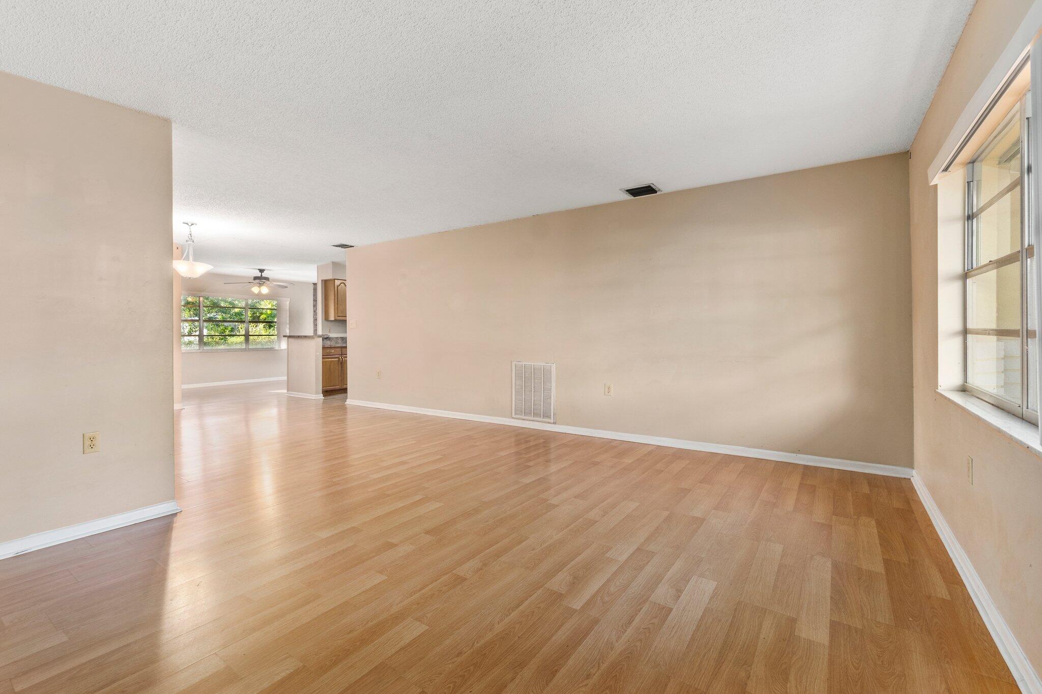 5901 Sunset Boulevard Fort Pierce, FL 34982 - Photo 8 of 26 wooden floor in an empty room with a window