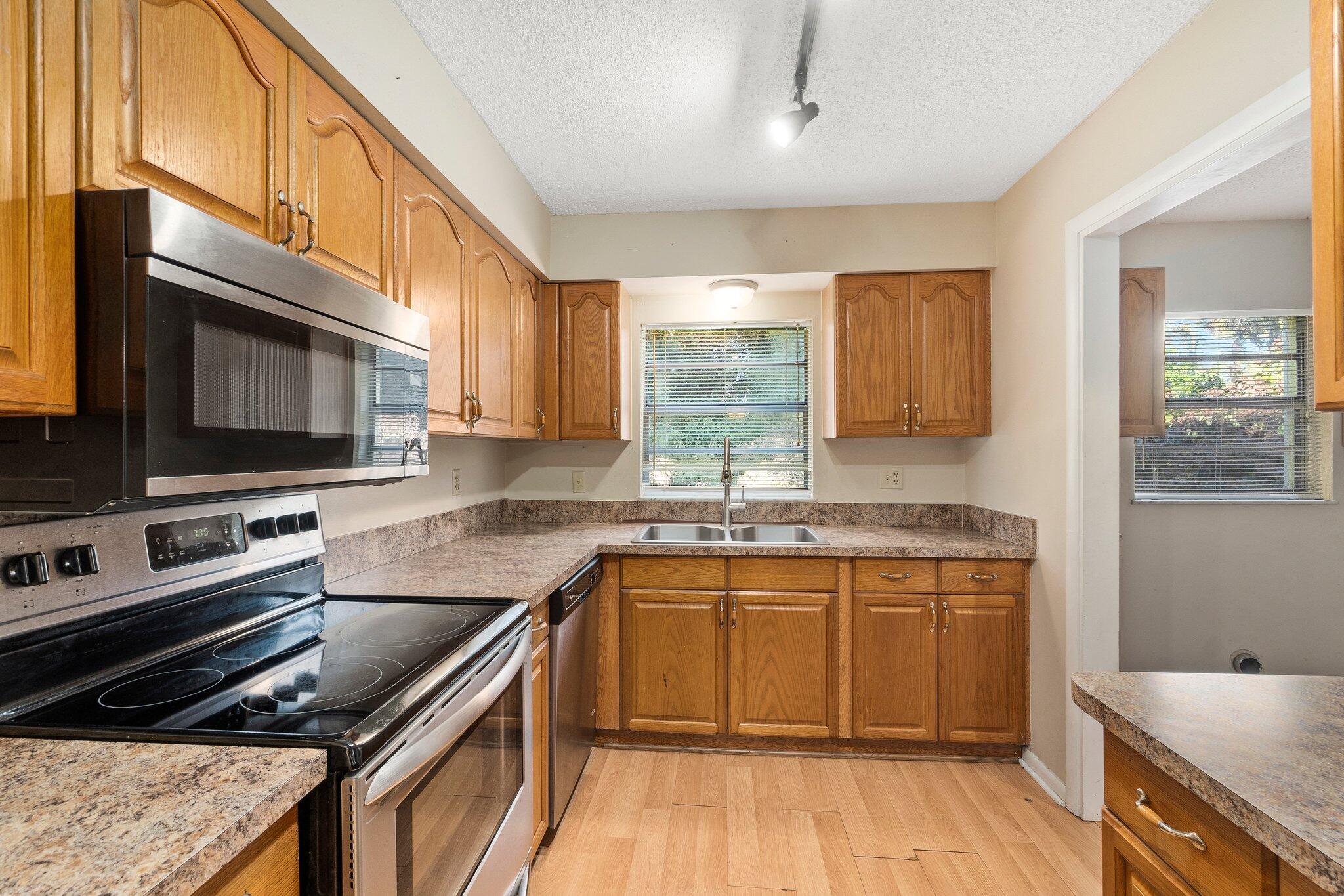 5901 Sunset Boulevard Fort Pierce, FL 34982 - Photo 10 of 26 a kitchen with a sink stove top oven and microwave