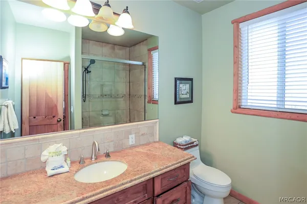 a bedroom with bed and a chandelier