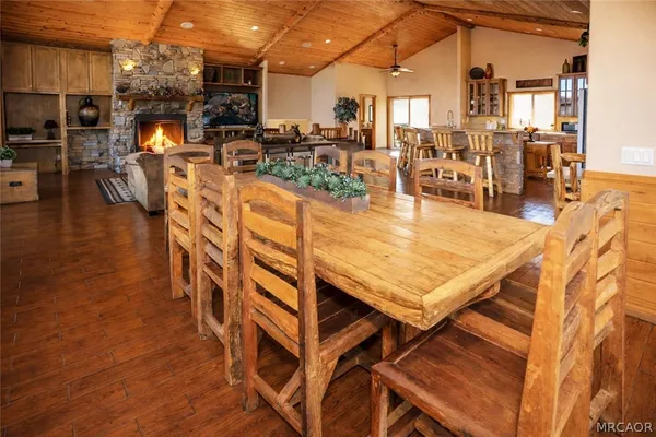 a living room with furniture a flat screen tv and kitchen view