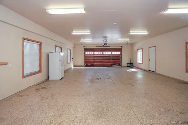 a room with pool table and windows