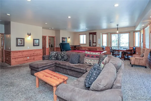 a bedroom with a bed and a dresser next to a window