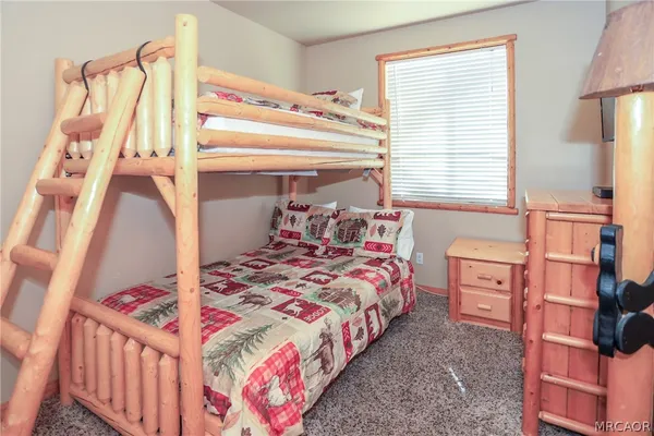 a view of a cafe with a couple of cars parked on road