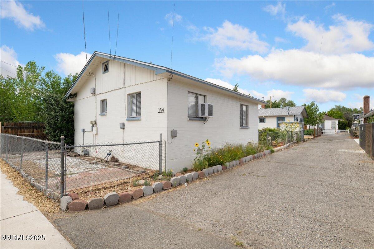154 East Arroyo Street Reno, NV 89502 - Photo 16 of 36 a view of a white house with a yard