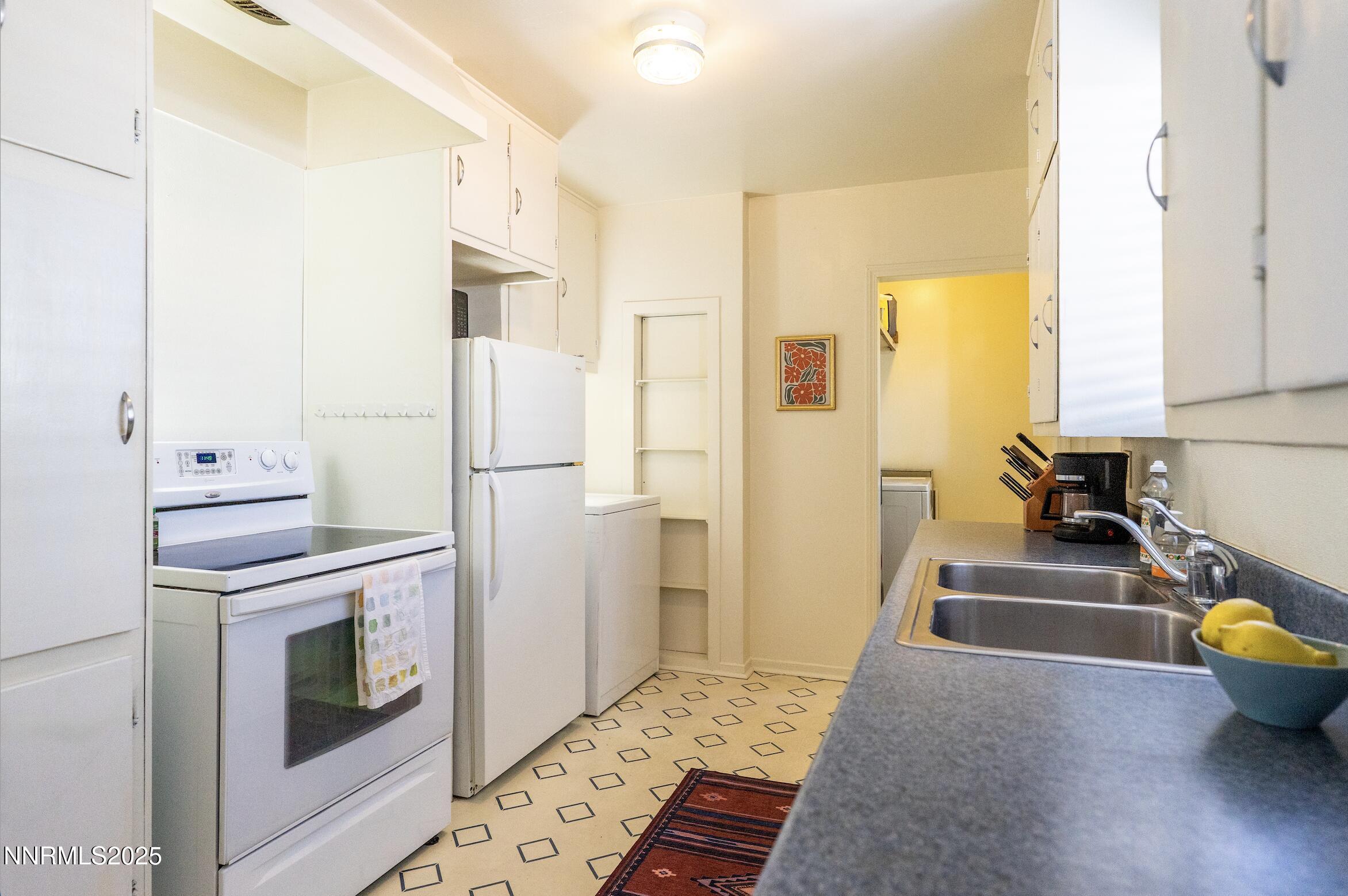 154 East Arroyo Street Reno, NV 89502 - Photo 22 of 36 a kitchen with stainless steel appliances a stove a refrigerator and cabinets