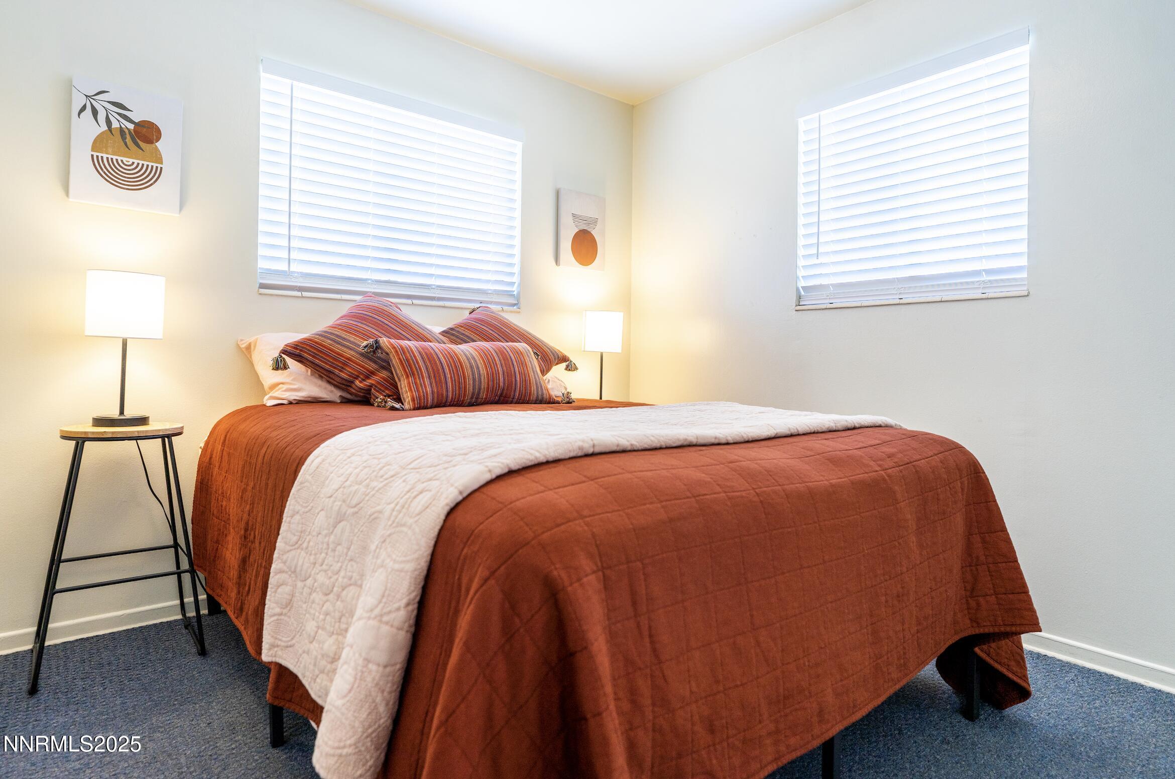 154 East Arroyo Street Reno, NV 89502 - Photo 24 of 36 a bedroom with a bed and a lamp next to a window