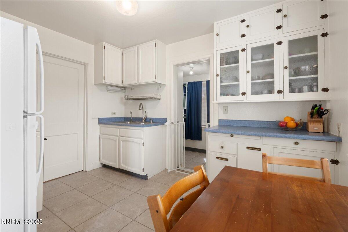 154 East Arroyo Street Reno, NV 89502 - Photo 5 of 36 a kitchen with a refrigerator and white cabinets