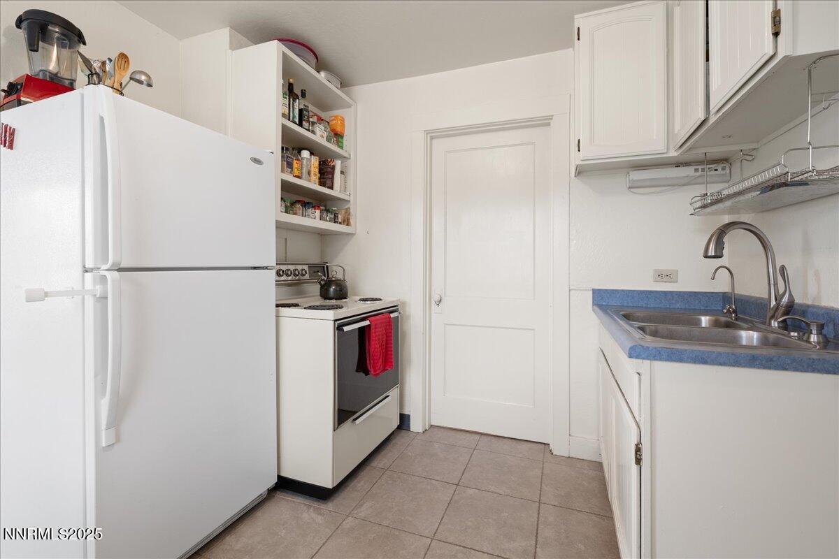 154 East Arroyo Street Reno, NV 89502 - Photo 6 of 36 a white refrigerator freezer sitting inside of a kitchen