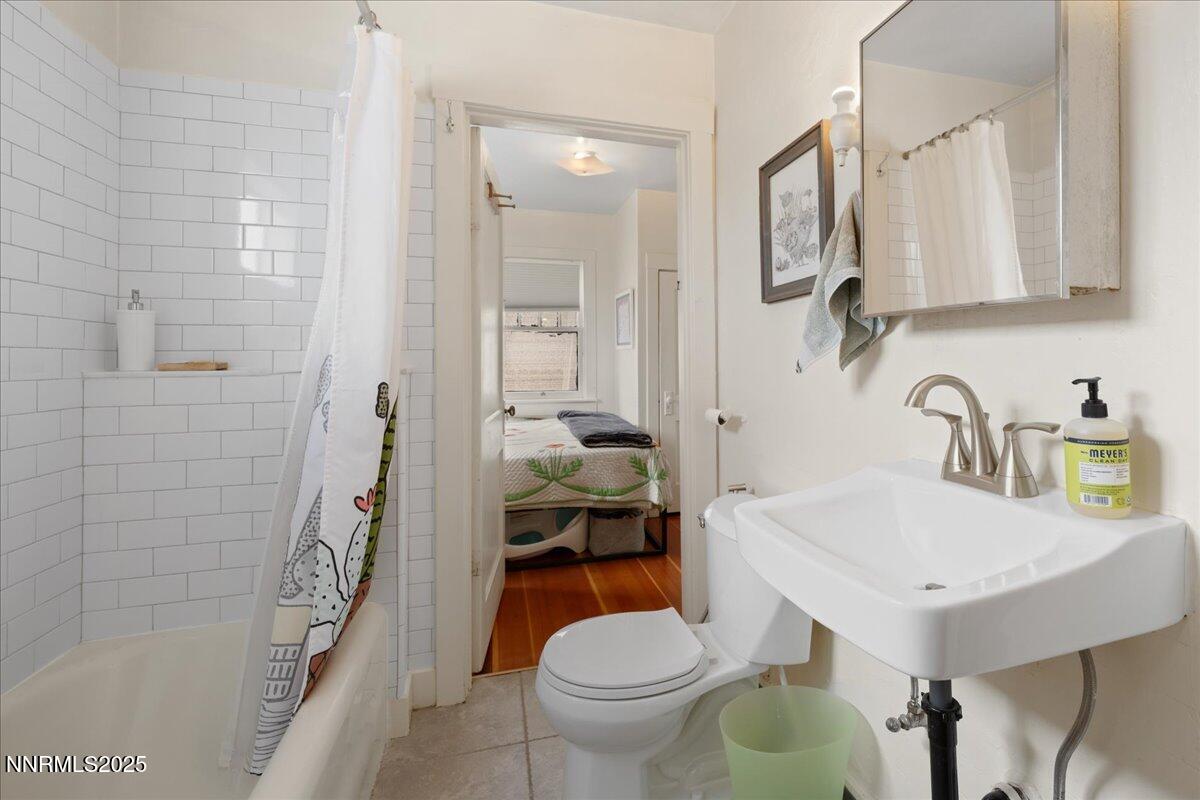 154 East Arroyo Street Reno, NV 89502 - Photo 10 of 36 a bathroom with a sink a toilet and shower