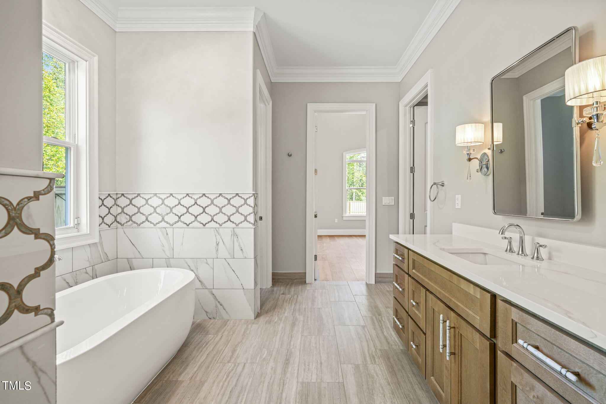 109 November Drive Durham, NC 27712 - Photo 31 of 57 a en suite bathroom with a double vanity sink a mirror and a bathtub