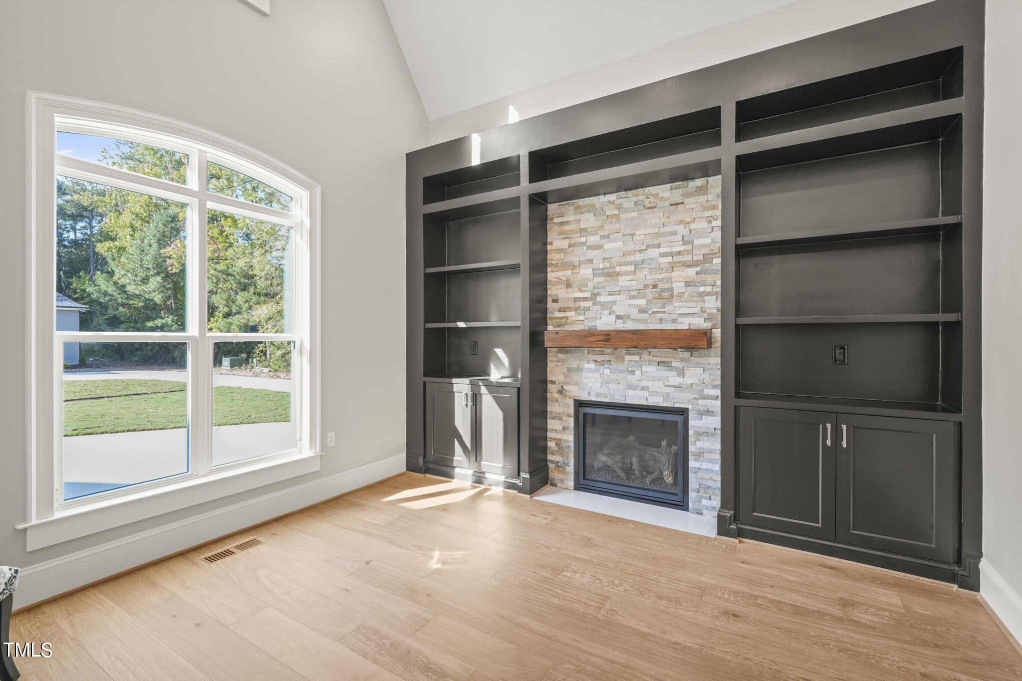 109 November Drive Durham, NC 27712 - Photo 4 of 57 a view of an empty room with a fireplace and a window