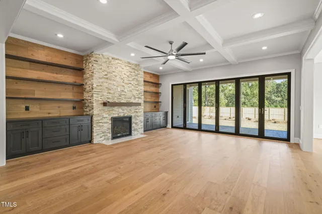 a view of empty room with a fireplace and windows