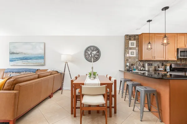 a kitchen with stainless steel appliances granite countertop a refrigerator a stove top oven a sink and dishwasher