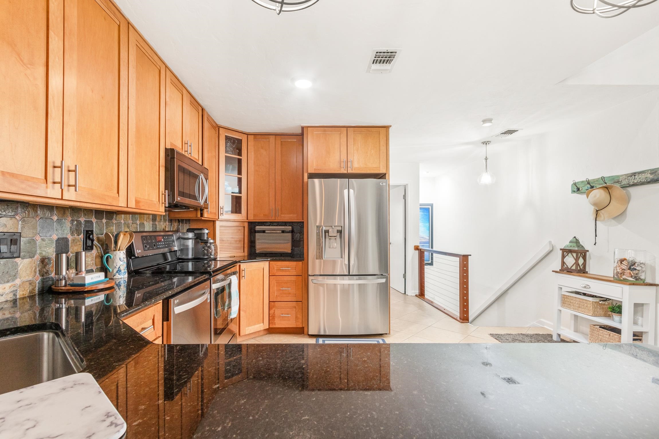 3385 Coastal Highway, Unit 22 St. Augustine, FL 32084 - Photo 13 of 35 a kitchen with stainless steel appliances granite countertop a refrigerator and a stove top oven