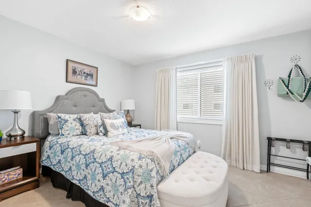 a bedroom with a bed and a lamp